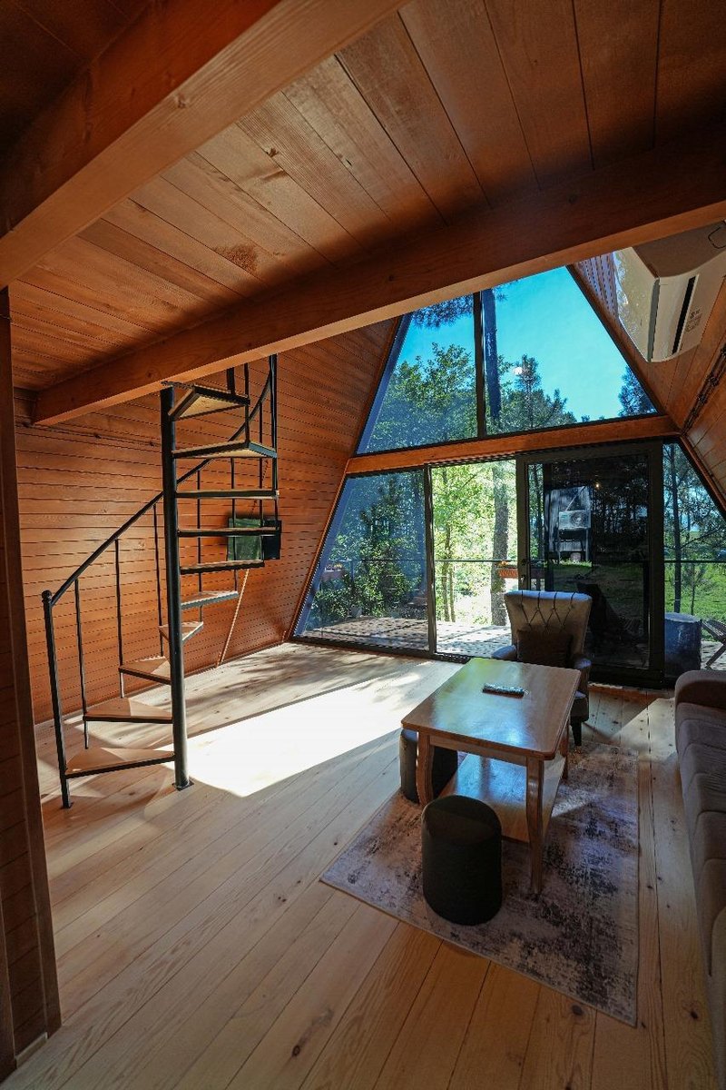 Wooden cottage interior with tall two-tiered windows